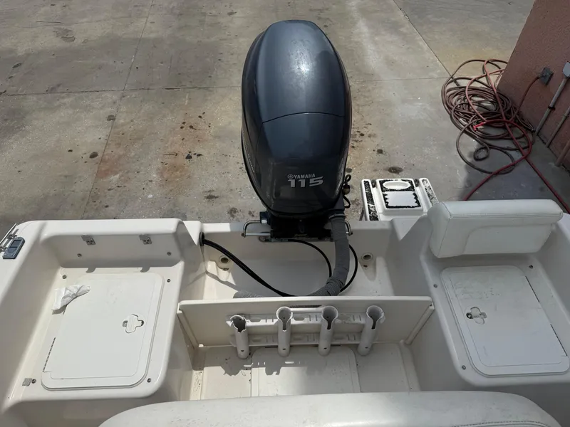 Slide: The Image of 2008 Cobia 194 Center Console boat with Yamaha 115 outboard motor, docked on concrete. - 10