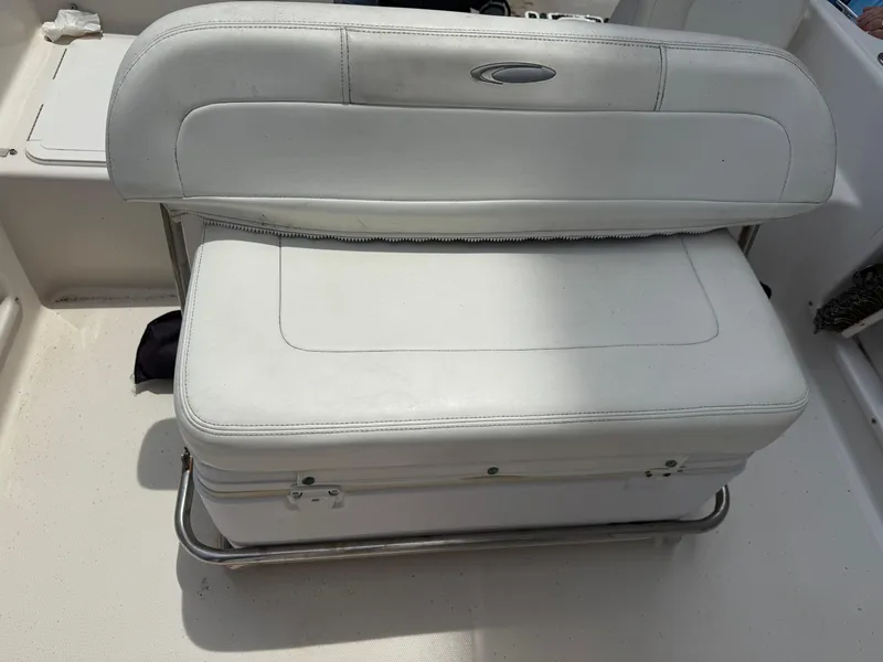 Slide: The Image of White cushioned seat on 2008 Cobia 194 Center Console boat, featuring storage underneath. - 14