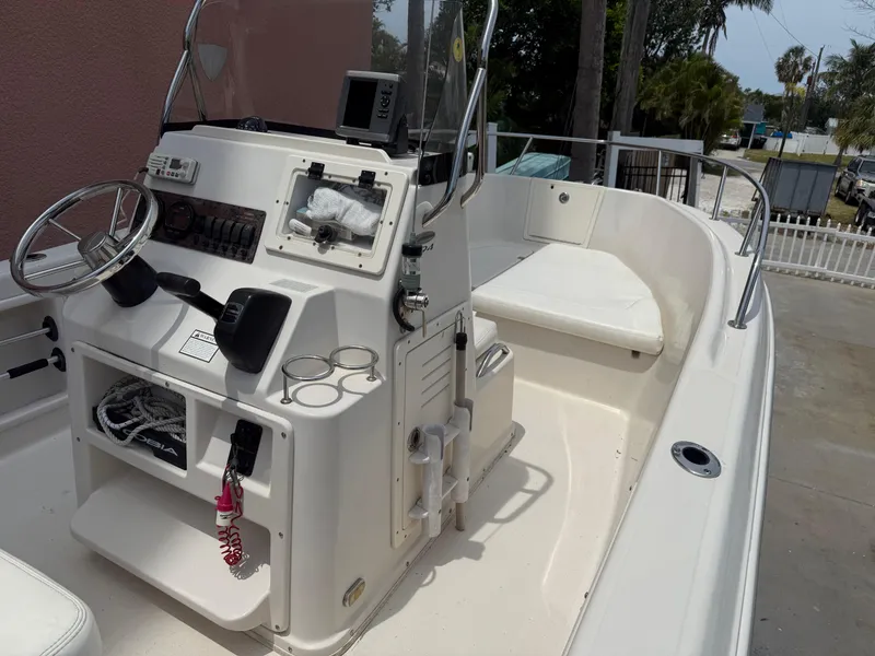 Slide: The Image of 2008 Cobia 194 Center Console boat with steering wheel and seating area. - 17