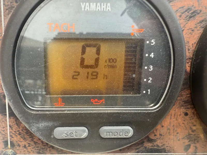 Slide: The Image of Yamaha tachometer displaying 219 hours on a 2008 Cobia 194 Center Console boat. - 18