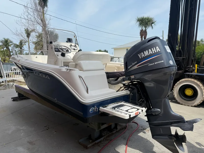 Slide: The Image of 2008 Cobia 194 Center Console boat with Yamaha outboard motor, docked outdoors. - 3