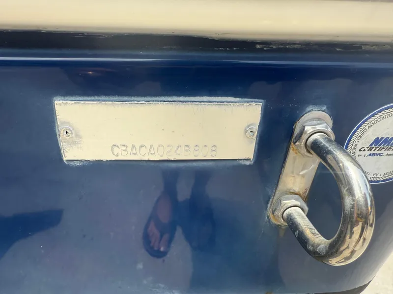 Slide: The Image of 2008 Cobia 194 Center Console boat with identification plate and metal handle. - 5