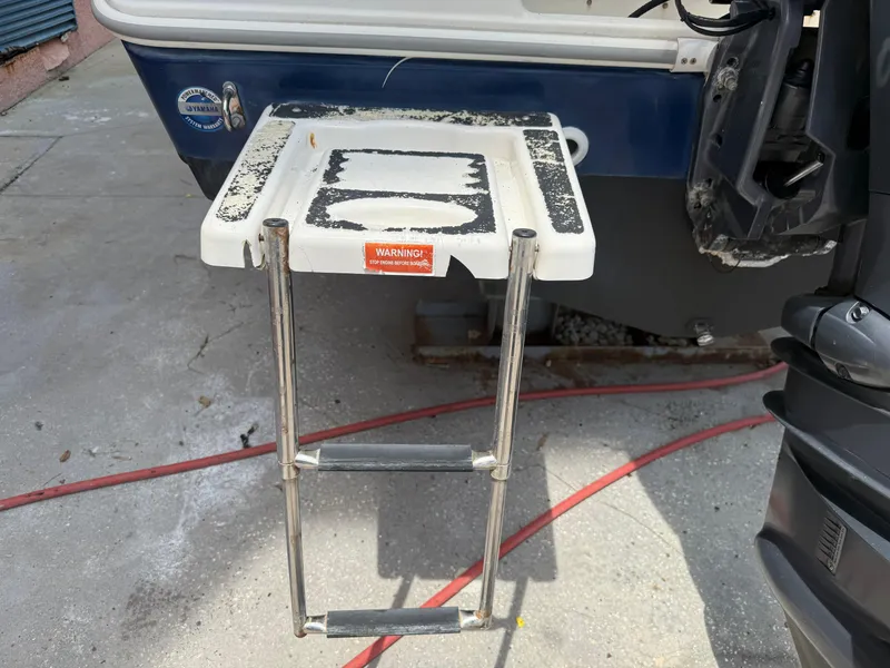 Slide: The Image of 2008 Cobia 194 Center Console boat with foldable swim ladder. - 6