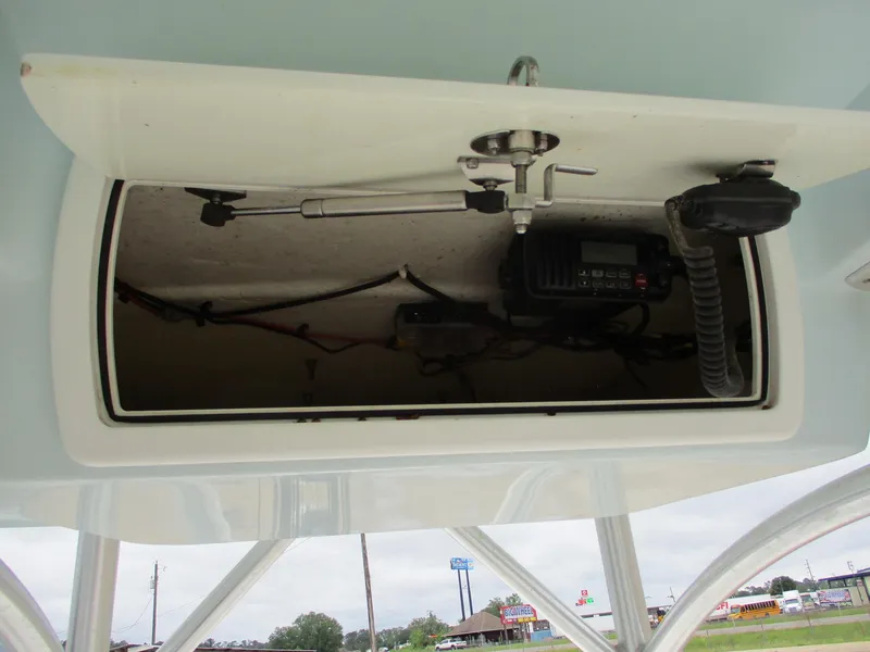 Slide: The Image of 2013 Sea Fox 240 Viper boat storage compartment with radio equipment. - 13