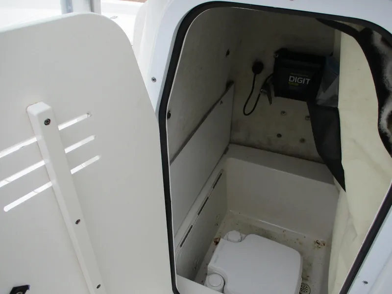 Slide: The Image of 2013 Sea Fox 240 Viper boat interior with compact marine toilet and storage. - 16
