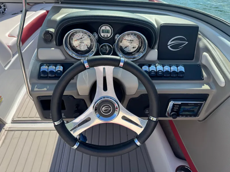 Slide: The Image of Steering wheel and dashboard of 2018 Crownline 225SS boat, featuring gauges and controls. - 11
