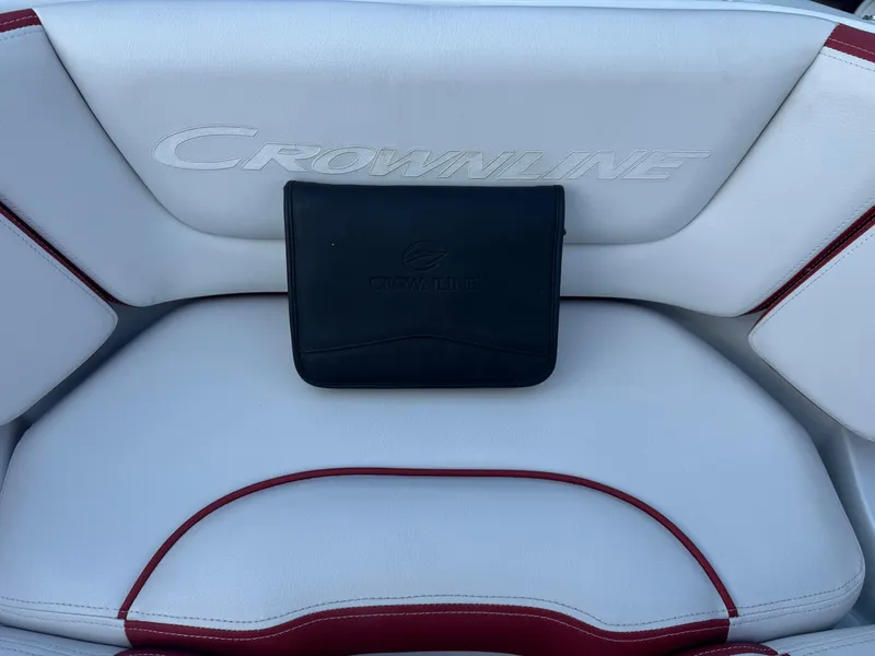 Slide: The Image of Crownline 225SS 2018 boat seat with branded pouch on white and red upholstery. - 12