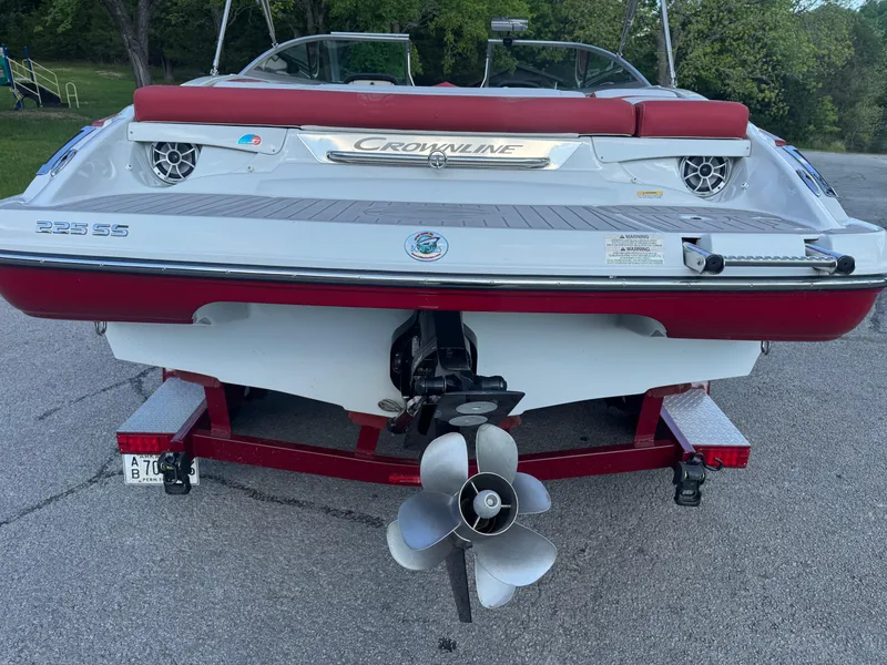 Slide: The Image of 2018 Crownline 225SS boat on trailer, rear view with propeller and red accents. - 15