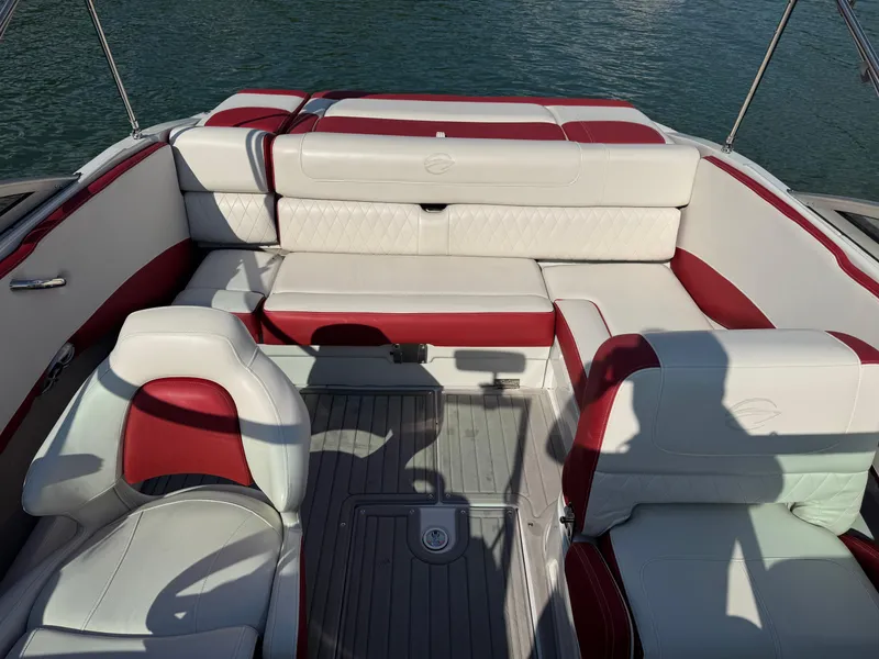 Slide: The Image of 2018 Crownline 225SS boat interior with red and white seating on water. - 4