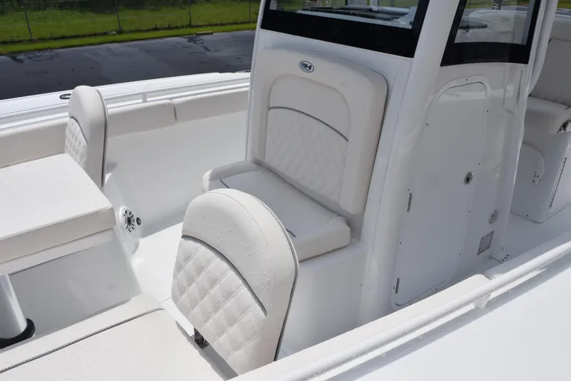 Slide: The Image of 2025 Sea Hunt Ultra 275 SE boat interior with white cushioned seating. - 12