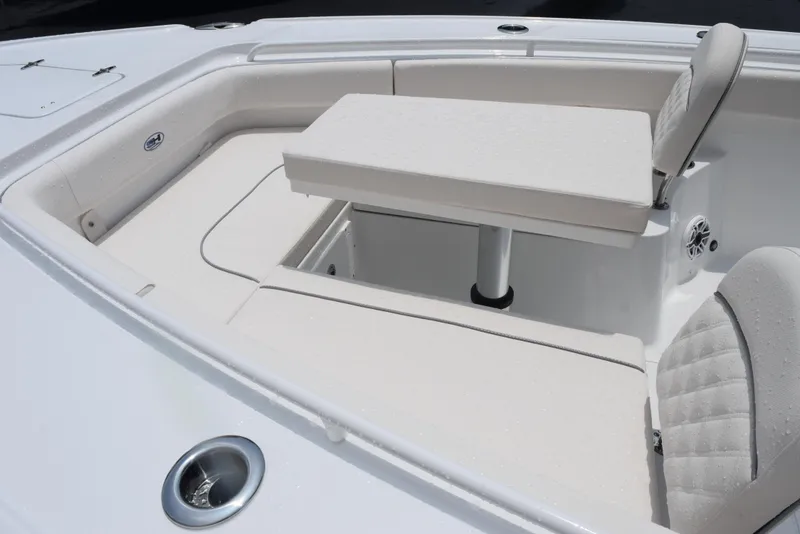 Slide: The Image of 2025 Sea Hunt Ultra 275 SE boat interior with cushioned seating and table. - 14