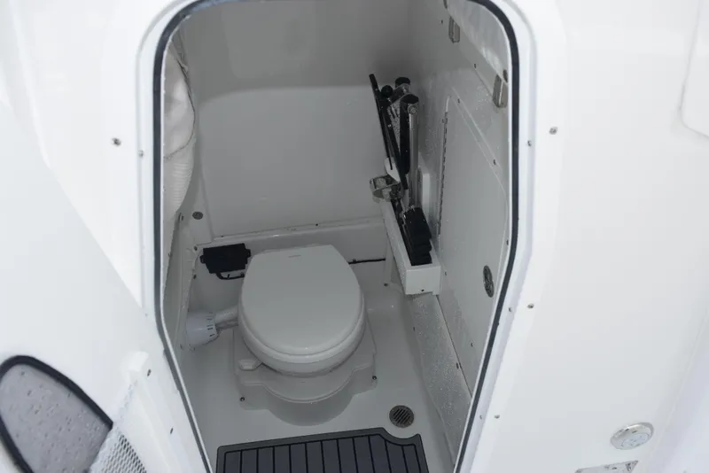 Slide: The Image of 2025 Sea Hunt Ultra 275 SE boat interior with compact marine toilet. - 16