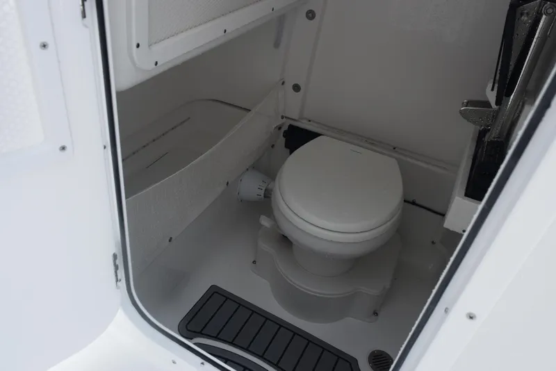 Slide: The Image of 2025 Sea Hunt Ultra 275 SE boat interior with compact marine toilet. - 17