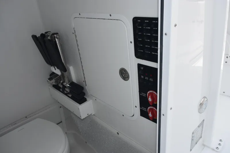 Slide: The Image of Interior of 2025 Sea Hunt Ultra 275 SE boat, featuring control panel and storage. - 18