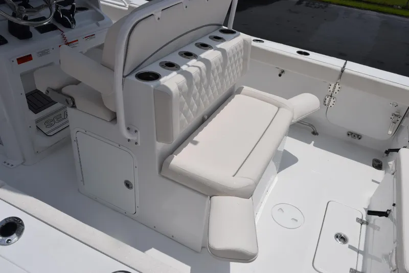 Slide: The Image of 2025 Sea Hunt Ultra 275 SE boat interior with cushioned seating and rod holders. - 8