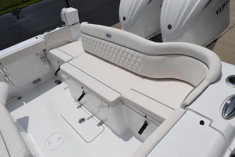 Slide: The Image of 2025 Sea Hunt Ultra 275 SE boat interior with white cushioned seating and dual engines. - 9