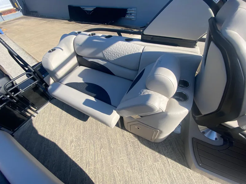 Slide: The Image of 2023 JC Sporttoon 26TT boat interior with luxurious seating and cup holders. - 11
