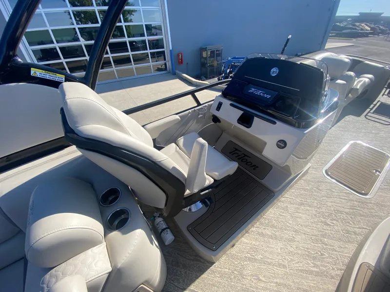 Slide: The Image of 2023 JC Sporttoon 26TT boat interior with modern helm and comfortable seating. - 12