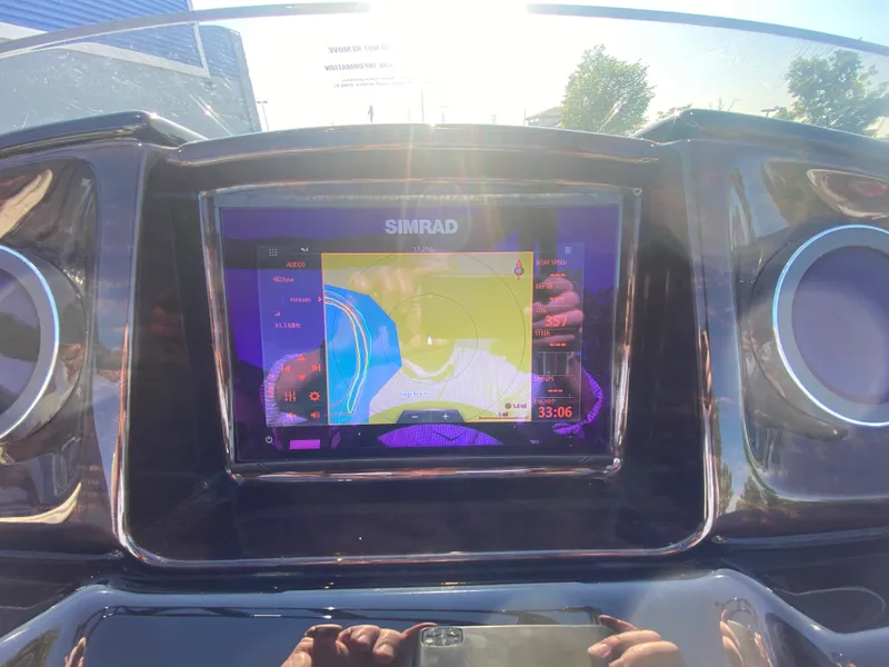 Slide: The Image of Dashboard of 2023 JC Sporttoon 26TT with Simrad navigation display. - 19