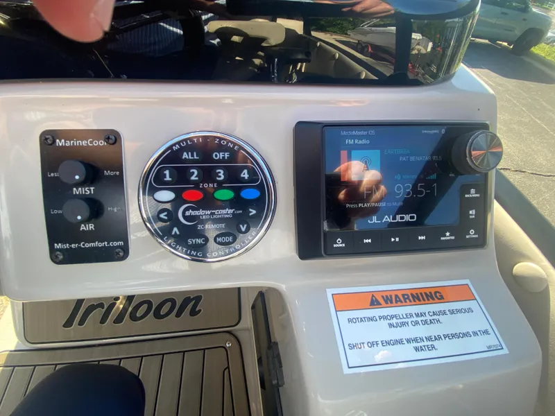 Slide: The Image of Control panel of a 2023 JC Sporttoon 26TT boat with audio system and warning label. - 23