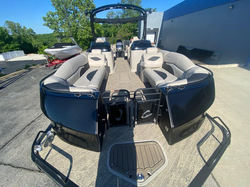 Slide: The Image of 2023 JC Sporttoon 26TT pontoon boat with spacious seating and sleek design, docked outdoors. - 29