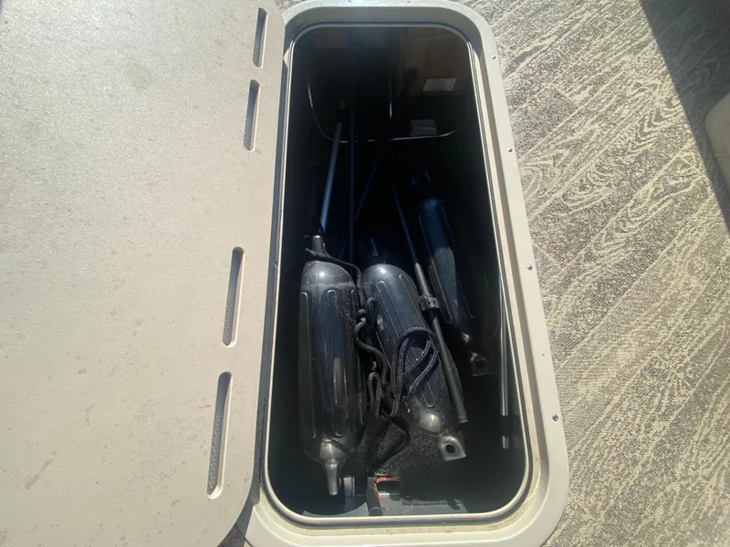 Slide: The Image of Storage compartment on 2023 JC Sporttoon 26TT boat with fenders and equipment. - 31