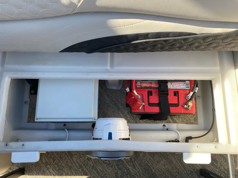 Slide: The Image of Battery compartment of 2023 JC Sporttoon 26TT boat, featuring dual red batteries. - 33