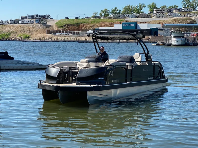 Slide: The Image of 2023 JC Sporttoon 26TT pontoon boat on a lake near a marina. - 37