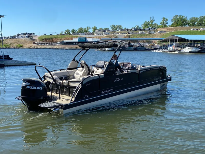 Slide: The Image of 2023 JC Sporttoon 26TT pontoon boat on a lake with Suzuki outboard motor. - 40