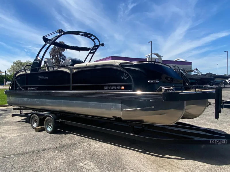 Slide: The Image of 2023 JC Sporttoon 26TT pontoon boat on trailer under clear blue sky. - 6