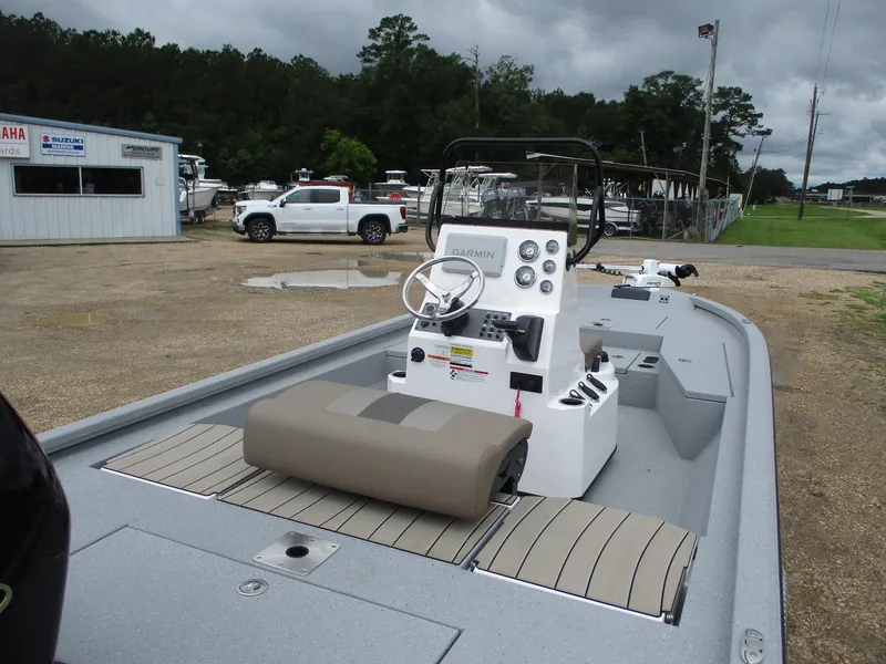 Slide: The Image of 2025 Vexus ACX2000 boat with console and seating, parked outdoors near dealership. - 10