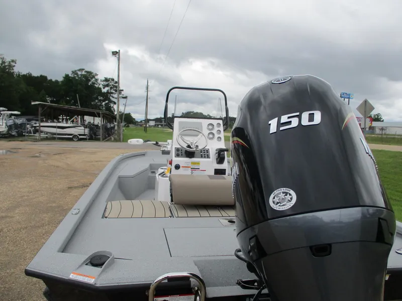 Slide: The Image of 2025 Vexus ACX2000 boat with 150 horsepower engine, parked outdoors under cloudy skies. - 4
