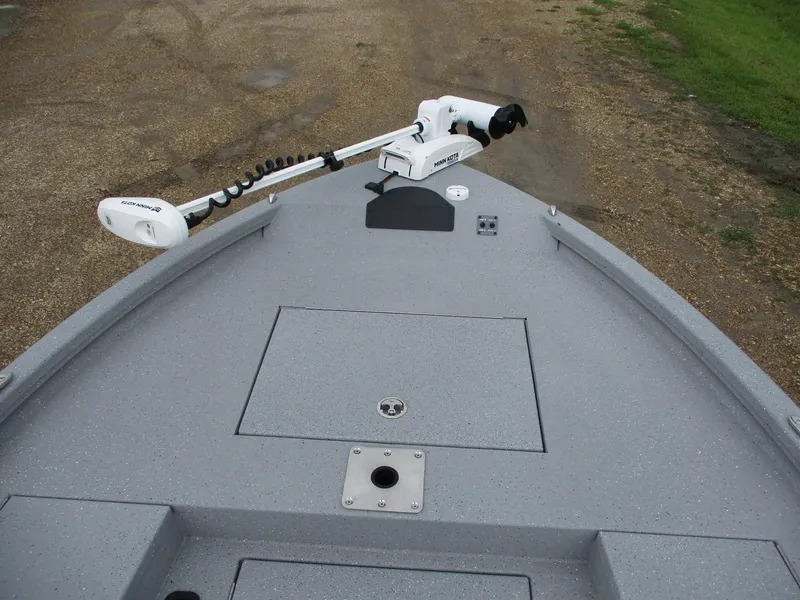 Slide: The Image of 2025 Vexus ACX2000 boat deck with trolling motor on gravel and grass background. - 6