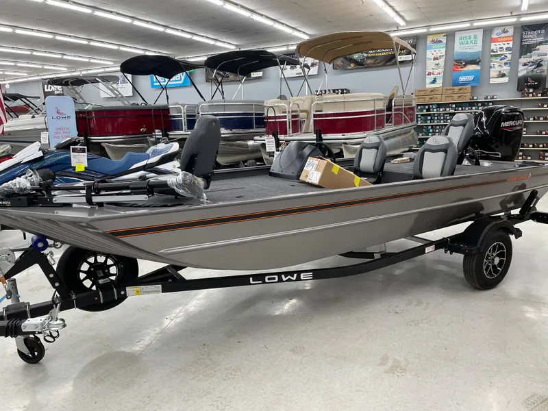 Slide: The Image of 2025 Lowe Legacy boat displayed in showroom, featuring sleek design and modern features. - 0