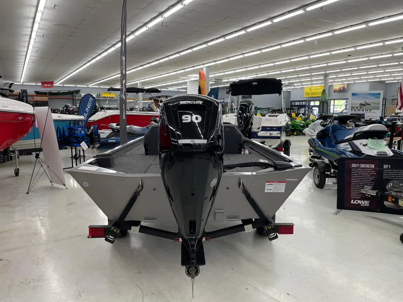 Slide: The Image of 2025 Lowe Legacy boat with 90 HP engine displayed in showroom. - 4