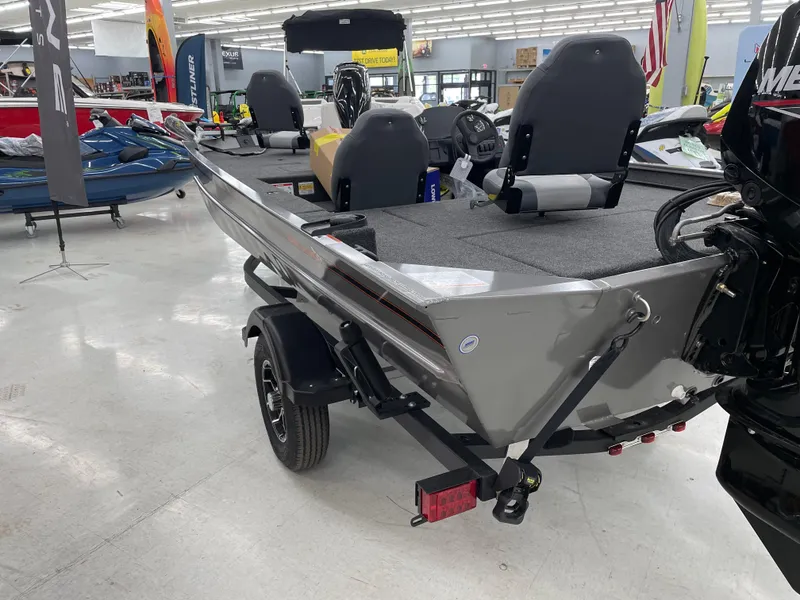 Slide: The Image of 2025 Lowe Legacy boat in showroom, featuring sleek design and modern seating. - 5