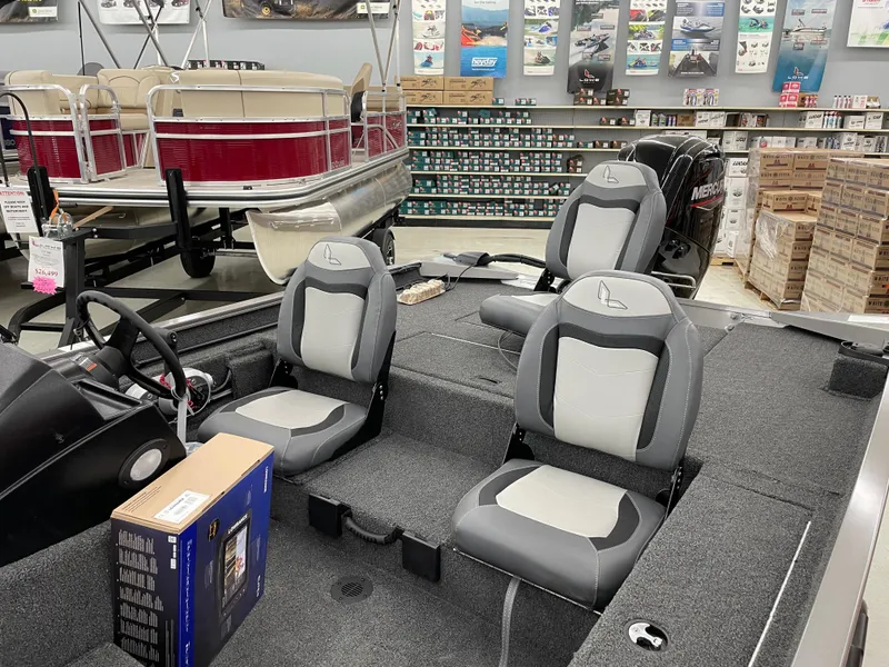 Slide: The Image of 2025 Lowe Legacy boat interior with gray seats in a showroom. - 7