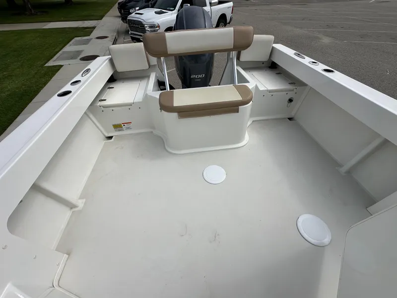 Slide: The Image of 2019 Parker 2120 Sport Cabin boat interior with seating and storage compartments. - 10