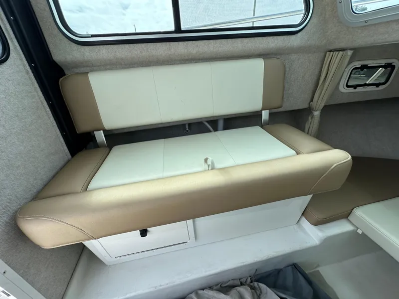 Slide: The Image of 2019 Parker 2120 Sport Cabin interior with beige and white seating. - 11