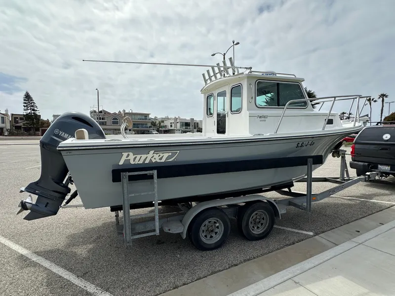 Slide: The Image of 2019 Parker 2120 Sport Cabin boat on trailer, parked outdoors. - 3