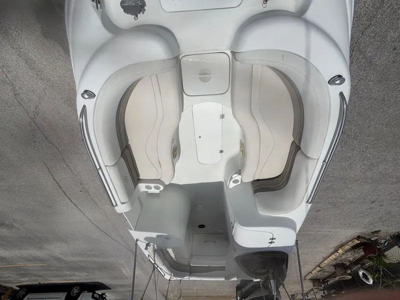 Slide: The Image of 2002 Monark Sunlounger 215 boat interior with white seating and storage compartments. - 10