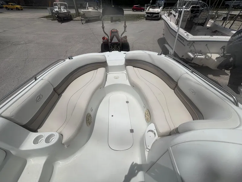 Slide: The Image of 2002 Monark Sunlounger 215 boat interior with white seating and cup holders. - 12