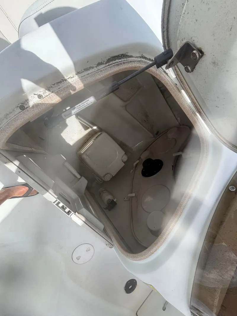 Slide: The Image of Open storage compartment on a 2002 Monark Sunlounger 215 boat. - 13