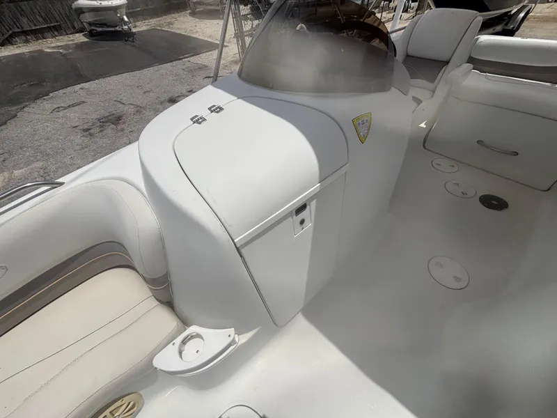 Slide: The Image of 2002 Monark Sunlounger 215 boat interior with white seating and storage compartments. - 14