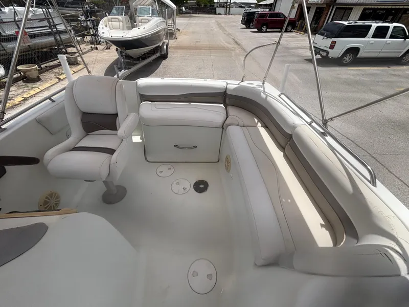 Slide: The Image of 2002 Monark Sunlounger 215 boat interior with white seating and storage compartments. - 16