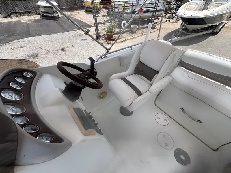 Slide: The Image of 2002 Monark Sunlounger 215 boat interior with steering wheel and seating. - 17