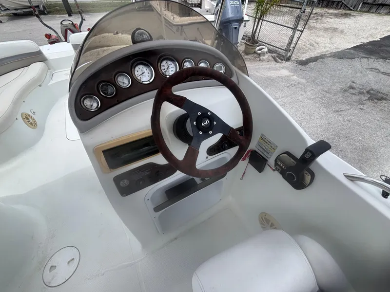 Slide: The Image of 2002 Monark Sunlounger 215 boat dashboard with steering wheel and gauges. - 19