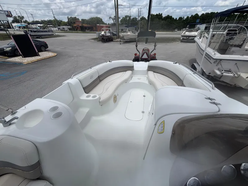 Slide: The Image of 2002 Monark Sunlounger 215 boat with spacious seating, docked in a marina. - 21