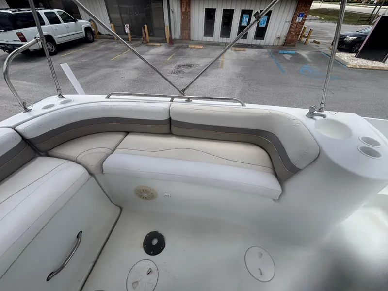 Slide: The Image of 2002 Monark Sunlounger 215 boat interior with cushioned seating and cup holders. - 22