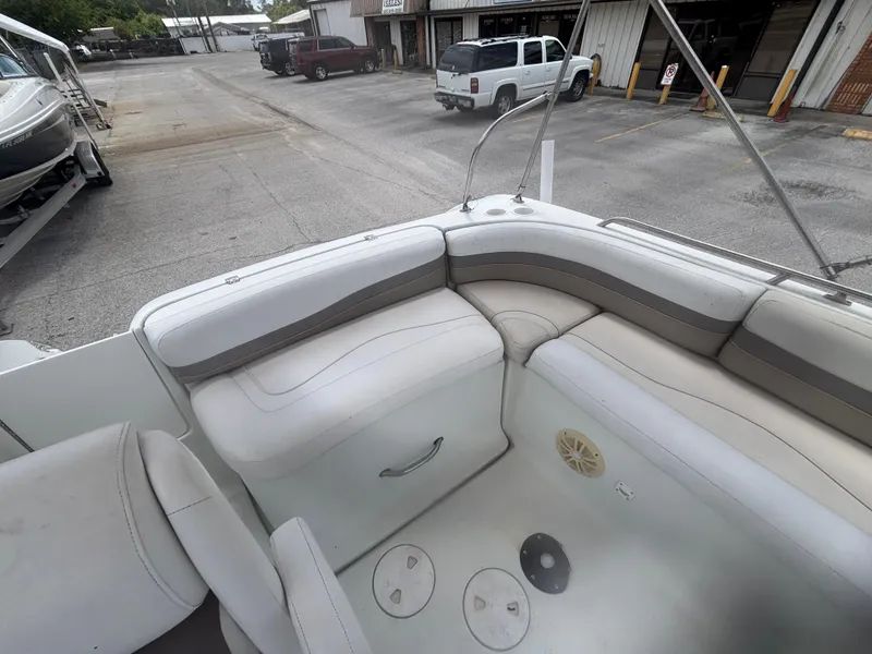 Slide: The Image of Interior of 2002 Monark Sunlounger 215 boat with white seating and storage compartments. - 23